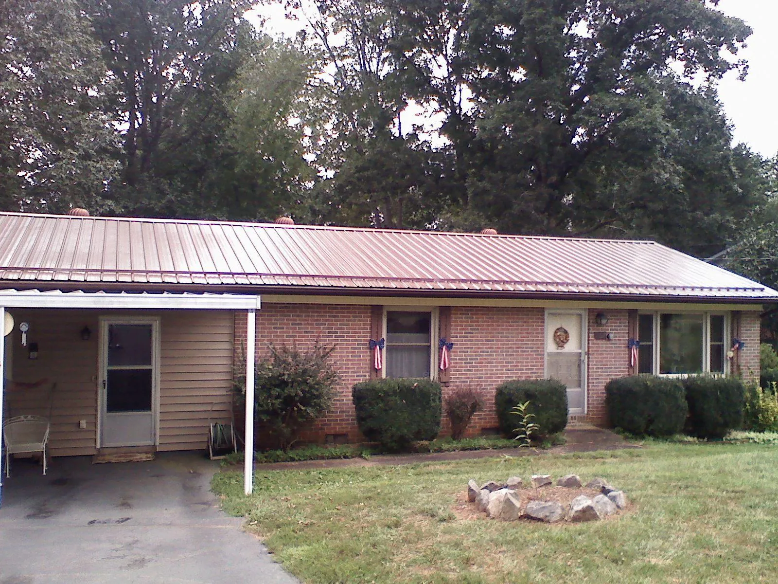 Bronze metal roof and carport on a brick ranch home — Roof Repair work by our crew in Owenton