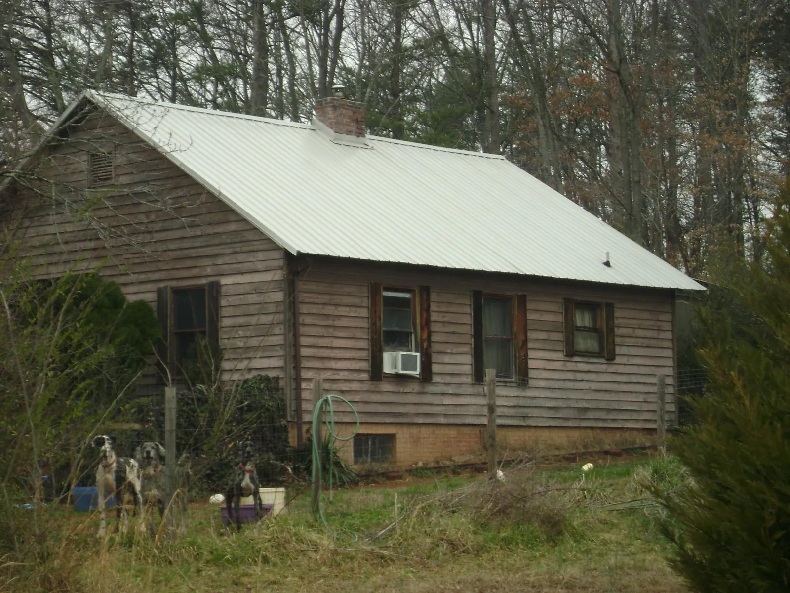 White metal roof on an old wood sided farmhouse, from a Metal Roof Installation job in Owenton